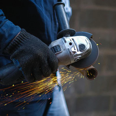 Cutting a pipe with a grinder and sparks flying